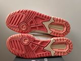 the soles of a pair of pink shoes on top of a box