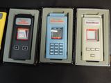 four cell phones are lined up in a row on a table