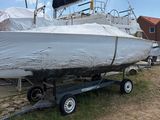 un bateau sur une remorque, recouvert d'une bâche