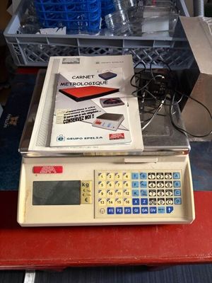 une balance posée sur une table, avec un livre dessus