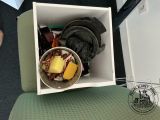 a bowl of food sitting in a box on a chair