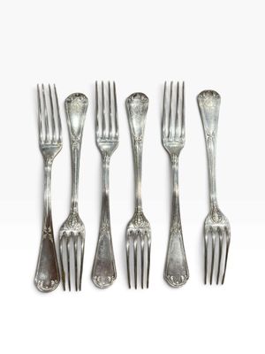 six forks and spoons are arranged in a row on a white surface