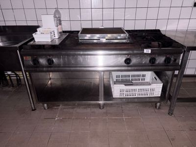 a kitchen with a stove, sink, and baskets on the counter