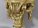 an image of a gold colored wall mounted shelf with a clock on it