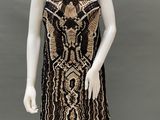 a mannequin wearing a black and gold dress on a mannequin