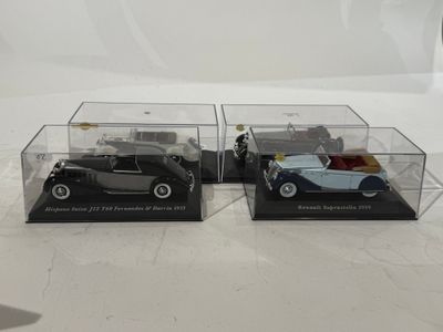 two model cars in a display case on a table