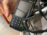 a person holding a cell phone with a cord attached to it