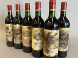 six bottles of wine lined up in a row on a table