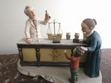 a figurine of a woman and a child sitting at a desk