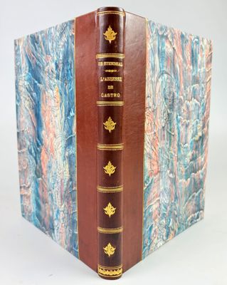 a close up of a book on a white surface with a blue and red background
