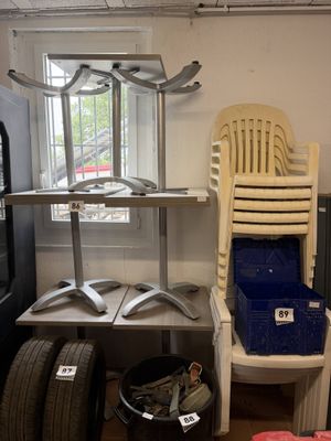 two chairs and a table in a room with a lot of tires