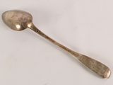 a spoon that is sitting on a white surface