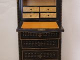 an image of a black and gold dresser with drawers and drawers