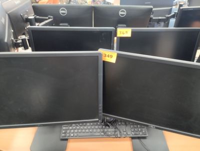 two computer monitors sitting on top of a desk
