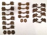 a lot of antique brass hardware on a white surface