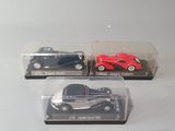 three toy cars that are sitting in a display case