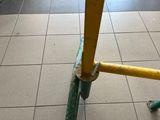 a yellow pole on the ground next to a green pole