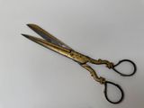 a pair of scissors on a table with a white background