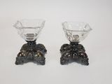 two glass vases sitting on top of each other