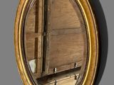 a mirror hanging on the wall next to a wooden door