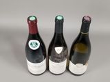three bottles of wine sitting next to each other on a table