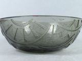 a glass bowl sitting on a table with a white background