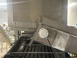 an image of a machine that is making donuts in a factory