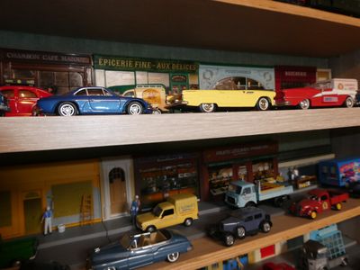 many toy cars on a shelf in a toy store