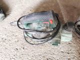 a bottle of water sitting on the floor next to a corded cord