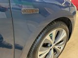a close up of a blue car with a sticker on it