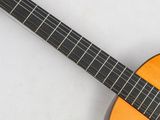 an image of a close up of a guitar on a white surface