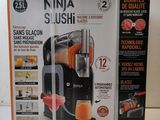 two boxes of ninja sushi juicer sitting on a table