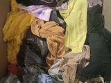 a cardboard box filled with clothes and a pair of shoes