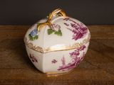 a white box with purple flowers on it on a wooden table