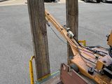 a brown suitcase sitting on top of a cart on the street