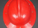 an image of a red fireman ' s helmet on a black background