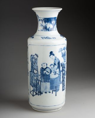 a blue and white vase with a picture of people on it