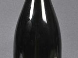 bottles of wine are lined up on a table with a gray background