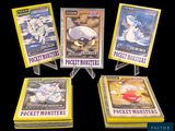 five pokemon trading cards are on display on a black background