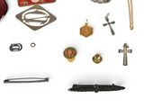 many different types of brooches and pins on a white surface