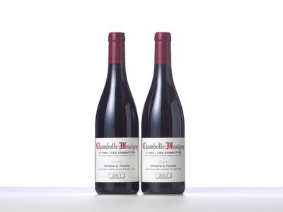 two bottles of red wine sitting on top of a table
