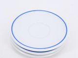 three white plates with blue rims sit on a white surface