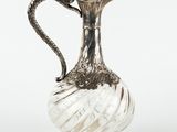an antique silver plated glass pitcher with a snake handle