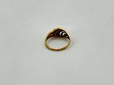 a close up of a gold ring on a white surface