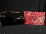 an image of a red and black purse and a red and white box