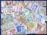a lot of different foreign currency on the table
