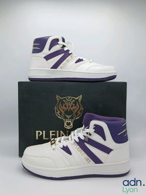 a pair of purple and white high top sneakers sitting on top of a box