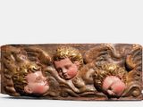 three heads of cherenshes on a piece of wood