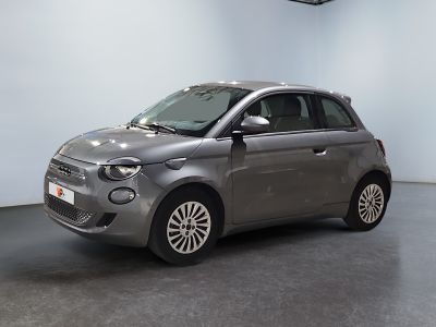 the small car is parked in the large room of the building