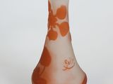 a small glass vase with a flower design on it